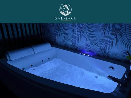 a bathtub in a room with a blue light at Salmace Luxury Apartment Jacuzzi privato in Bari