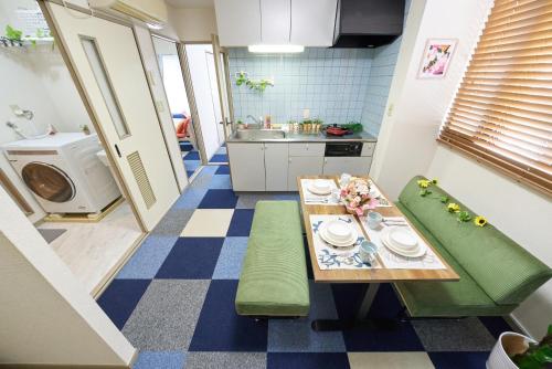 a small kitchen with a table and a sink at AO101 - Tokyo Stay Spacious Apartment Direct Train to Narita & Asakusa in Tokyo