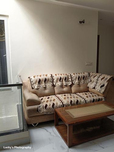 a living room with a couch and a coffee table at BELLA VISTA Homestay BNB in Zirakpur