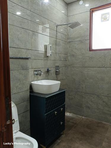 a bathroom with a sink and a toilet at BELLA VISTA Homestay BNB in Zirakpur