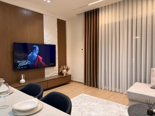 a living room with a flat screen tv on a wall at Coastal Luxe Retreat Durres in Durrës