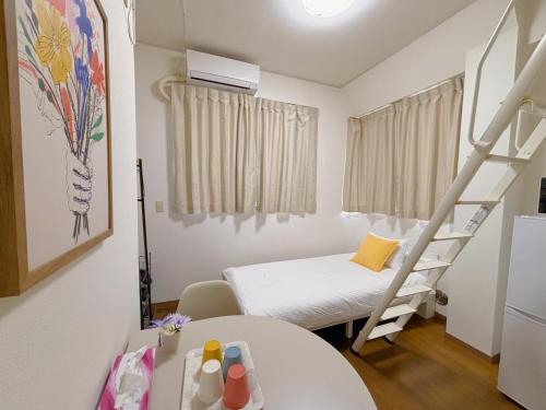 Ένα ή περισσότερα κρεβάτια σε δωμάτιο στο Mori house ookubobiru