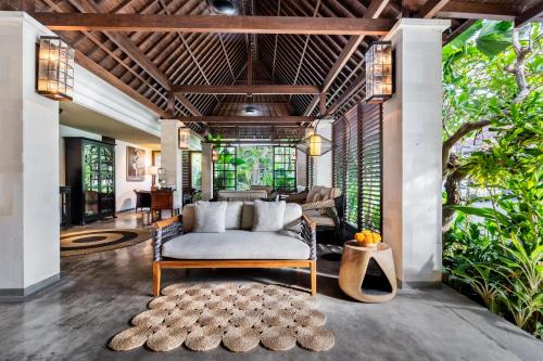 a living room with a couch and a table at Kejora Suites in Sanur