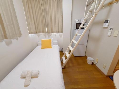 Ένα ή περισσότερα κρεβάτια σε δωμάτιο στο Mori house ookubobiru