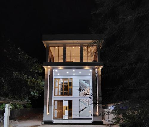 a house with a white facade at night at Hottel White tower in Point Pedro