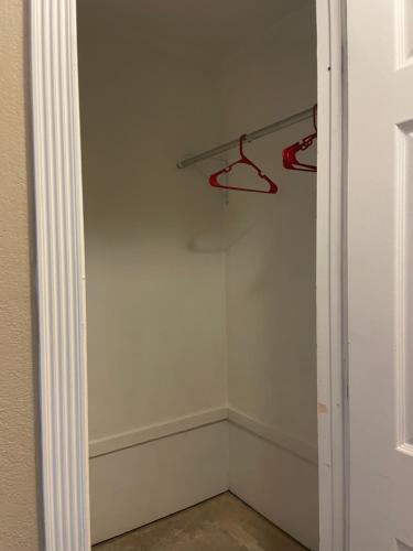 an empty closet with a hanger in a room at Studio Full kitchen private gated yard Arts Roosevelt row ASU convention ctr Downtown Phx in Phoenix