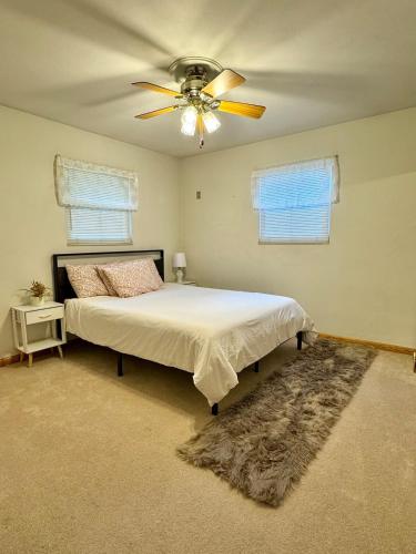 a bedroom with a bed and a ceiling fan at Bridgeport House WV, Close to UHC, FBI, The Bridge Complex in Bridgeport