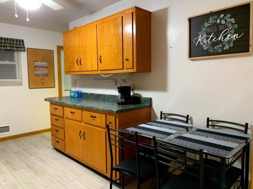 a kitchen with a counter and a table with chairs at Bridgeport House WV, Close to UHC, FBI, The Bridge Complex in Bridgeport