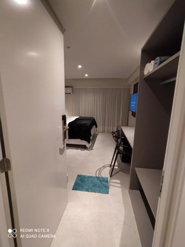 a room with a door open to a room with a couch at Flat Beira Mar, Arpoar João Pessoa in João Pessoa