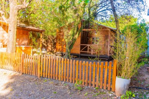 a wooden fence in front of a house at Cabaña Antonella by Renty in Encarnación
