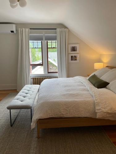 a bedroom with a large bed and a window at Bright, Spacious Home with Lake & Mountain Views, Walk to Beach in Nelson