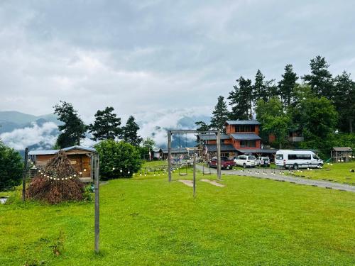 a park with a volley ball net in the grass at Heshkili huts and cabins Svaneti in Keshkili