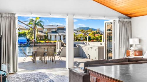 a kitchen and living room with a view of the water at Friendship Key in Forster