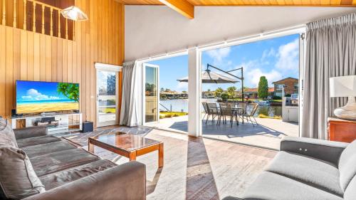 a living room with a view of the ocean at Friendship Key in Forster