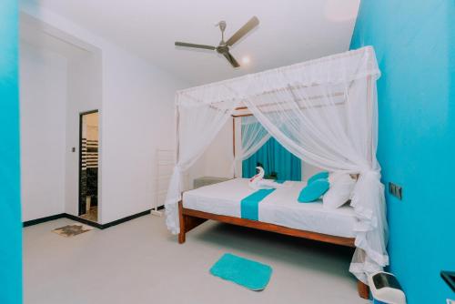 ein Schlafzimmer mit einem Bett mit Moskitonetz in der Unterkunft The ransi House in Dikwella