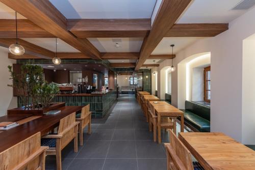 an empty restaurant with wooden tables and benches at TUIWA Garden Holiday Villa in Qingdao