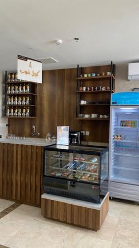 a store with a display case and a refrigerator at بالمز للشقق المخدومه in Sufan