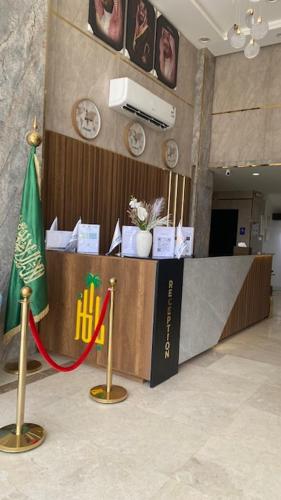 a desk in a room with a flag and clocks at بالمز للشقق المخدومه in Sufan