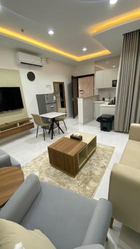 a living room with a couch and a coffee table at بالمز للشقق المخدومه in Sufan