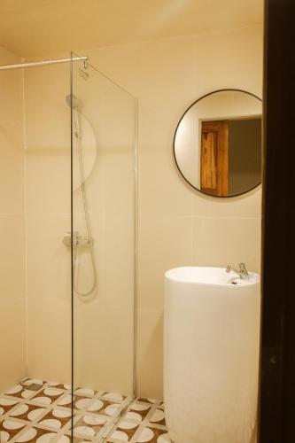 a bathroom with a sink and a glass shower at Metro Pratunam Boutique Hotel in Pratunam