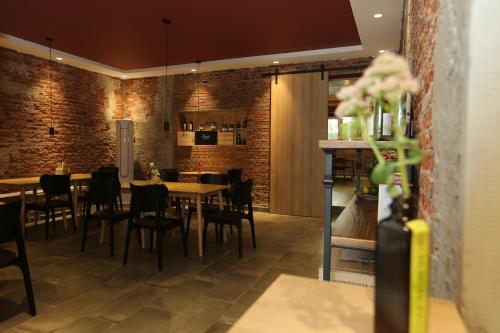 a restaurant with brick walls and tables and chairs at Beijing MutianyuGreat Wall Let'sgo Hotel&Bar in Huairou