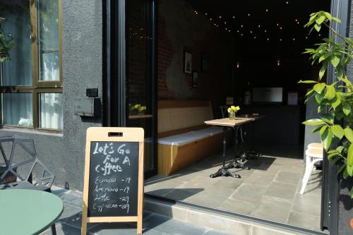 a restaurant with a chalkboard sign next to a table at Beijing MutianyuGreat Wall Let'sgo Hotel&Bar in Huairou