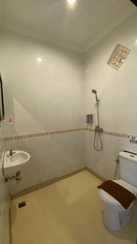 a bathroom with a toilet and a sink at Surya Inn in Kuta