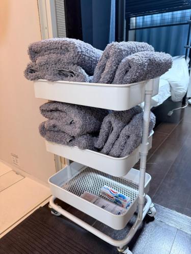 a towel rack with towels on it in a room at ワカバハウス in Wada