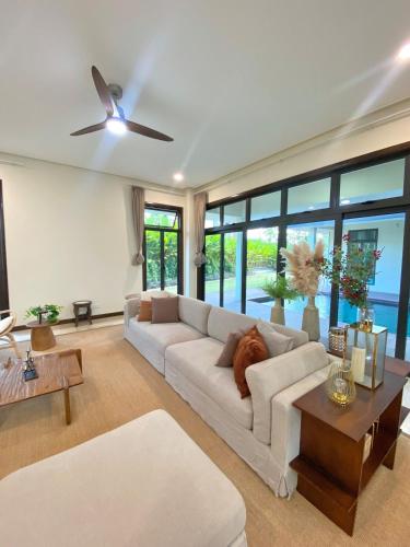 a living room with a white couch and a ceiling fan at Fajar Loft in Putrajaya