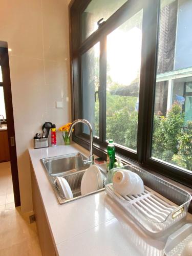 a kitchen sink with a window next to it at Fajar Loft in Putrajaya