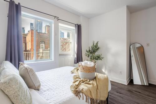 a bedroom with a bed and a large window at Luxurious 4 BR Suite in Griffintown in Montréal