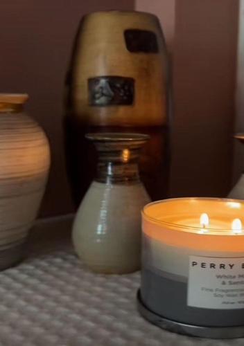 a candle and vases sitting on a table at Relaxing 2 bedroom with AC, WiFi, Central Location in Golconda