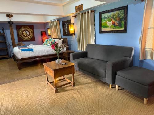 a living room with a couch and a bed at On The Mekong Resort in Luang Prabang