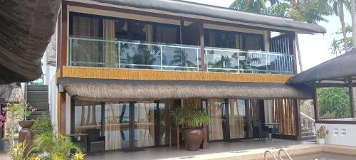 a building with a balcony with plants on it at The Ananyana Beach Resort by SMS Hospitality in Panglao