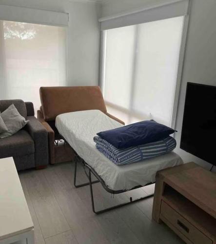 a living room with a bed and a couch at Beach House Getaway 2 in Smiths Beach