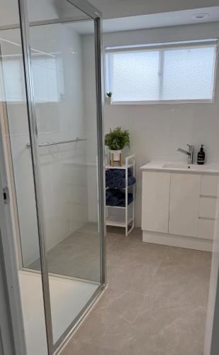 a glass shower in a bathroom with a sink at Beach House Getaway 2 in Smiths Beach