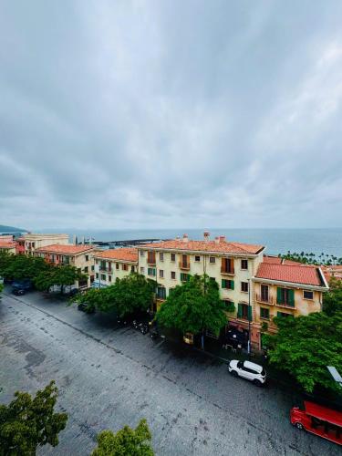 a building with a car parked in a parking lot at Great Hotel Phú Quốc in Phu Quoc