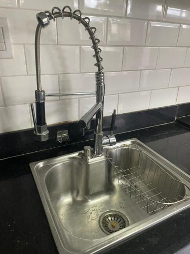 a kitchen sink with a water faucet in it at casa cop 30 in Ananindeua