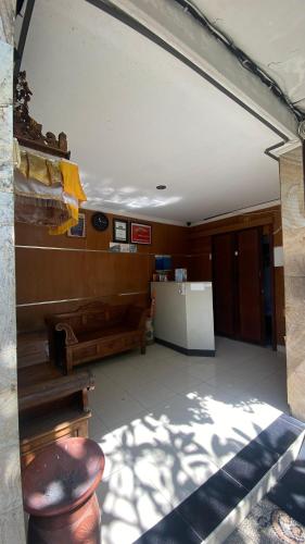 a room with a bench and a table in a building at Surya Inn in Kuta