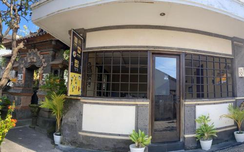 a store front with plants in front of it at Surya Inn in Kuta