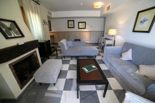 a living room with two couches and a fireplace at Villa Turística de Laujar de Andarax in Laujar de Andarax