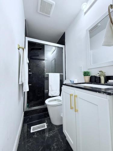 a bathroom with a shower and a toilet and a sink at Three Bedroom Spacious Bangalow with Free Parking, closer to commercial area and highways in Mississauga