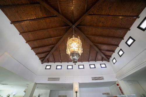 a chandelier hanging from a wooden ceiling in a building at Villa Turística de Laujar de Andarax in Laujar de Andarax