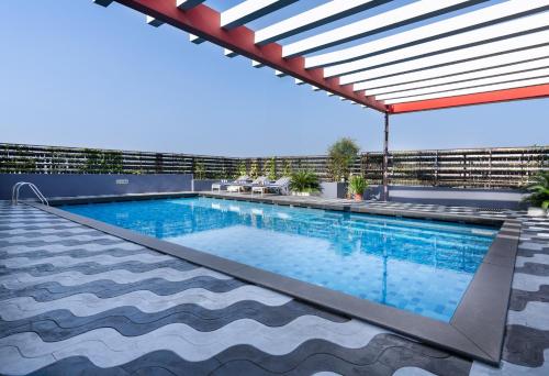 a swimming pool on the roof of a building at Presidency Kochi City Centre in Cochin