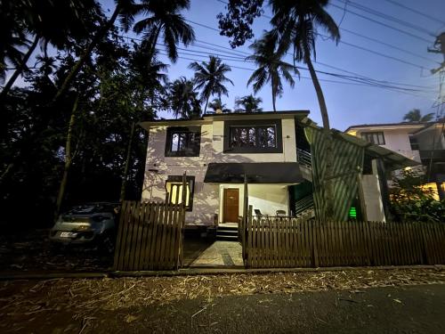 a house with a fence in front of it at Verde Sol by Célara Aurum - 2BHK Villa with Pool, BBQ & Ice Bath in Panaji