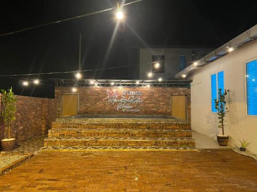 a brick wall with stairs in a room with lights at D'Iman Homestay Private Pool in Ketereh