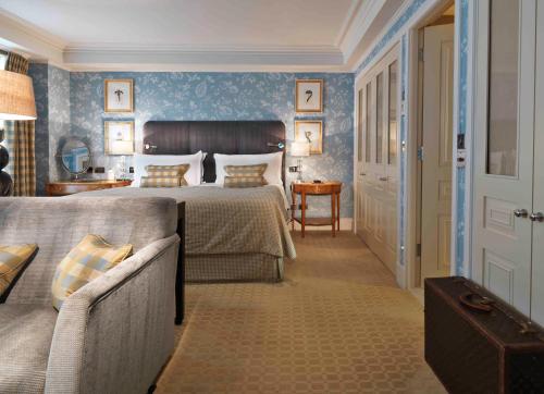 a bedroom with a bed and a couch at The Stafford London in London