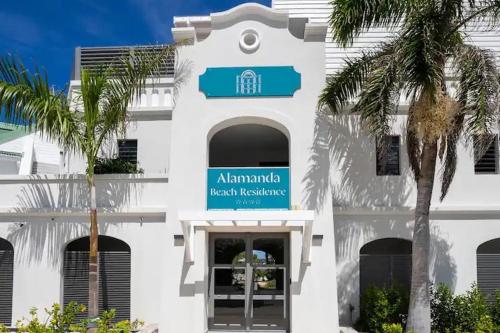 a white building with a sign on the front of it at orient bay studio -alamanda front de mer in Orient Bay