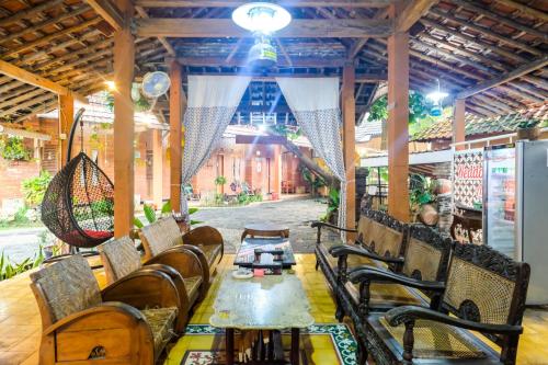 a restaurant with a table and chairs in a pavilion at RedDoorz Syariah near Akmil Magelang in Magelang