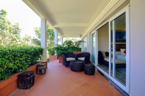 a patio with chairs and a table on a house at Mercury Phu Quoc Resort & Villas in Phu Quoc